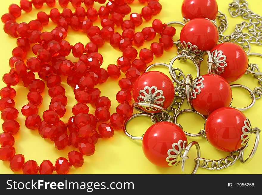 Red beads on a yellow background. Red beads on a yellow background