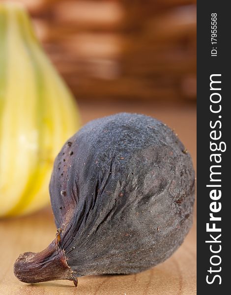 Ripe fruits of a fig on a wooden table.