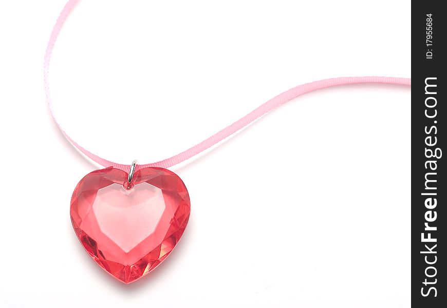 Pink heart of stone with a pink ribbon on a white