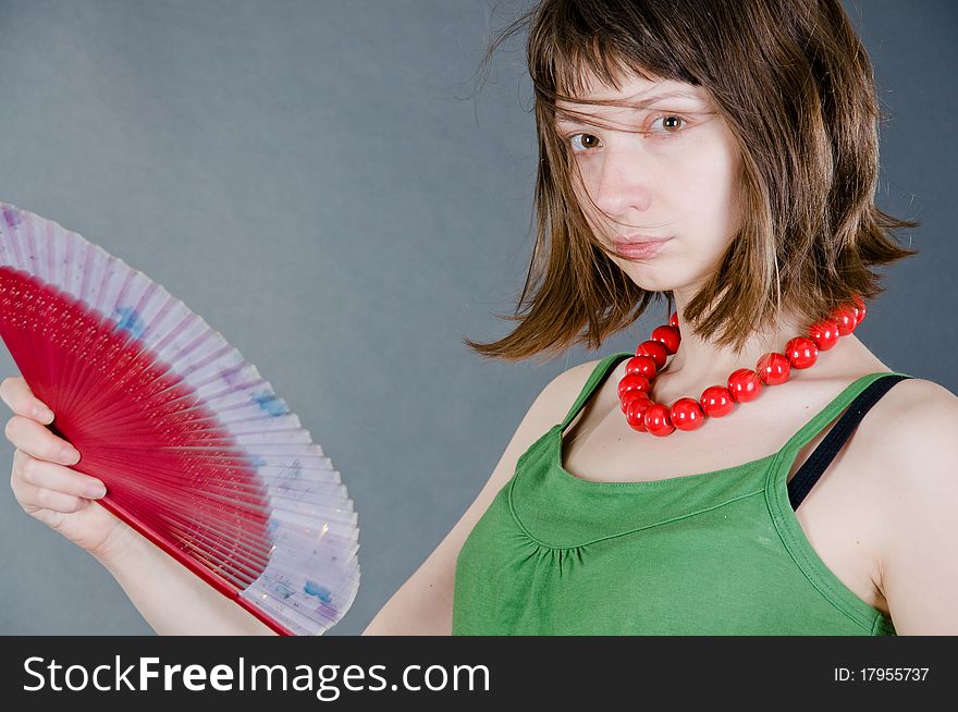 Girl with a fan on a black background