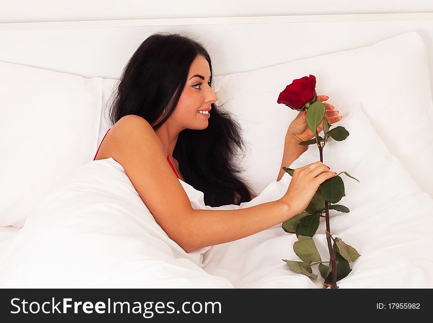 Girl lying in bed with gifts, roses, woke up, asle