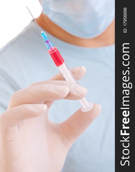 Professional doctor with medical syringe in hands, getting ready for injection