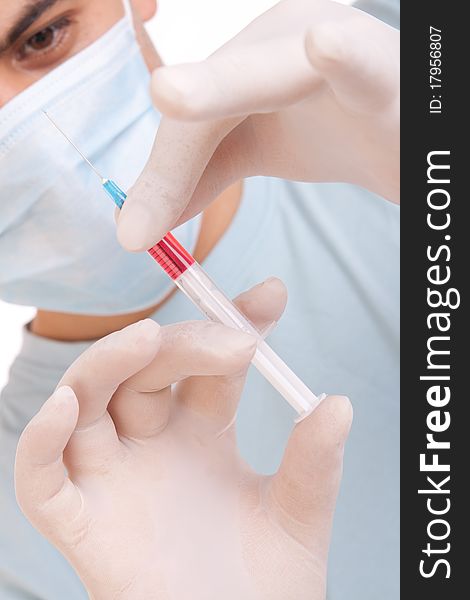 Professional doctor with medical syringe in hands, getting ready for injection