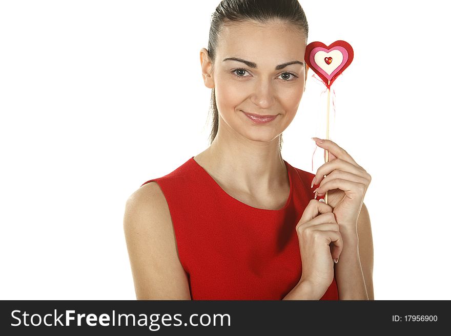 Young elegant female in red dress holding heart shape isolated on white. Young elegant female in red dress holding heart shape isolated on white