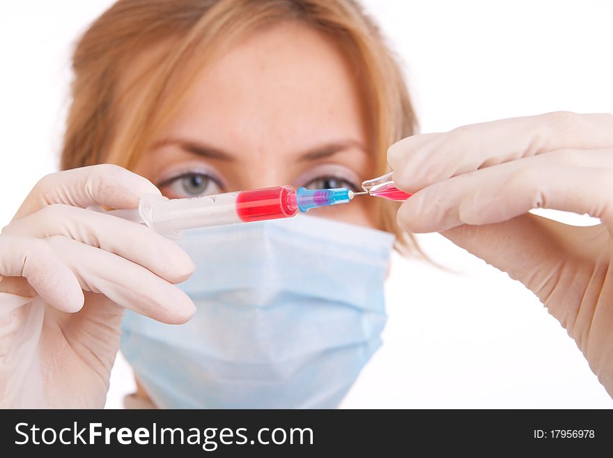 Professional doctor with medical syringe in hands, getting ready for injection