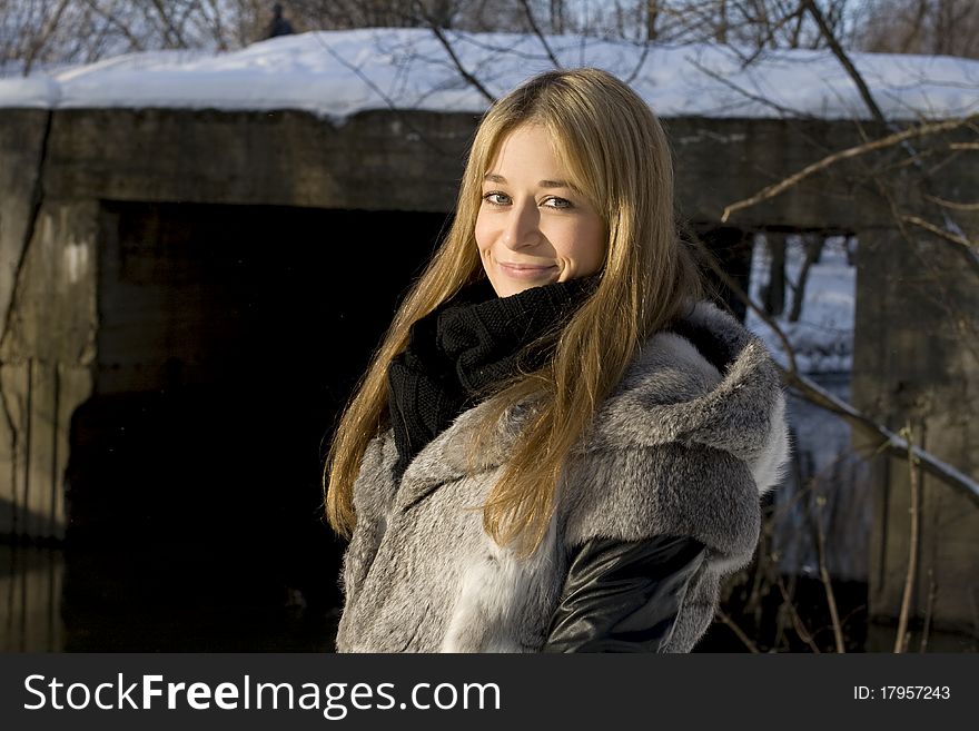 Smiling girl walking in winter forest