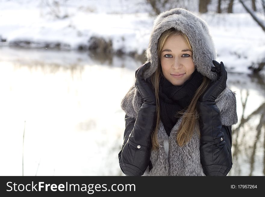 Closeup portrait of a pretty girl in winter forest