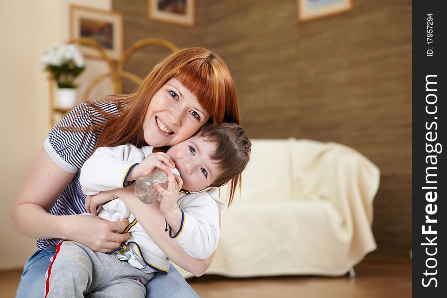 Young mother playing with her little son