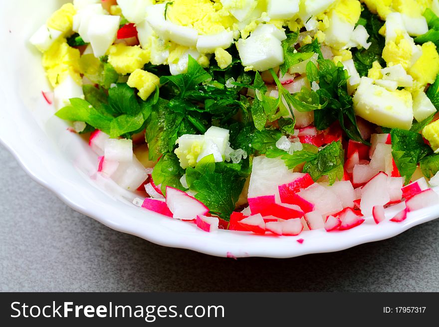 Creative vegetable salad with egg on the plate