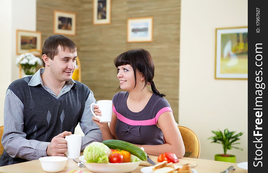 Young couple in love at home eating together and having fun. Young couple in love at home eating together and having fun