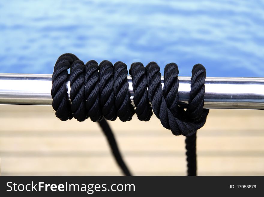 Black sailing rope wired on the metal pipe