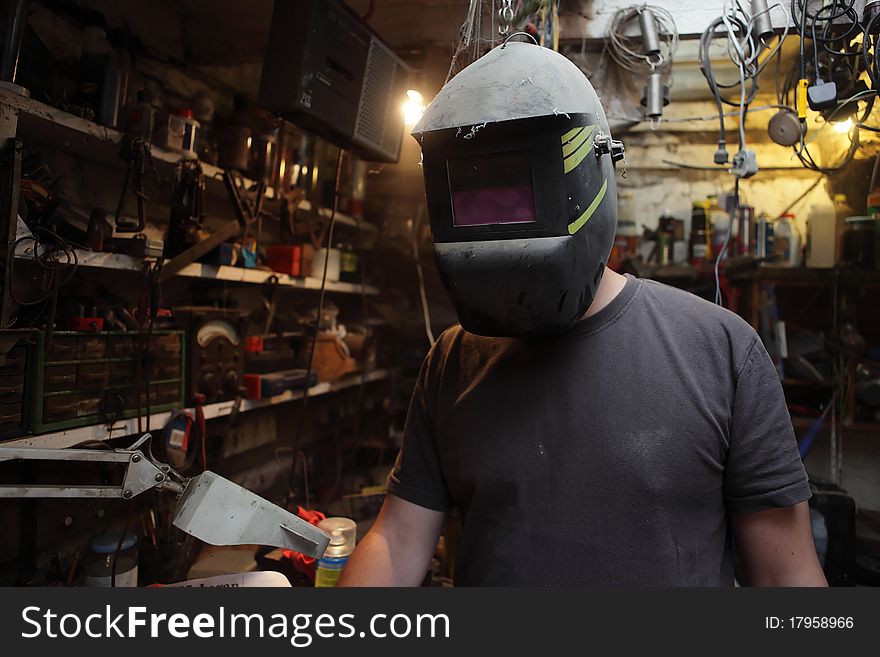 Welder working in an old workshop