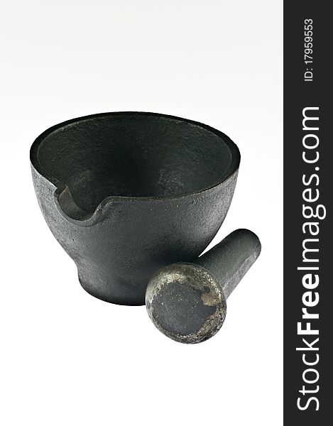 Old iron mortar with pestle on white