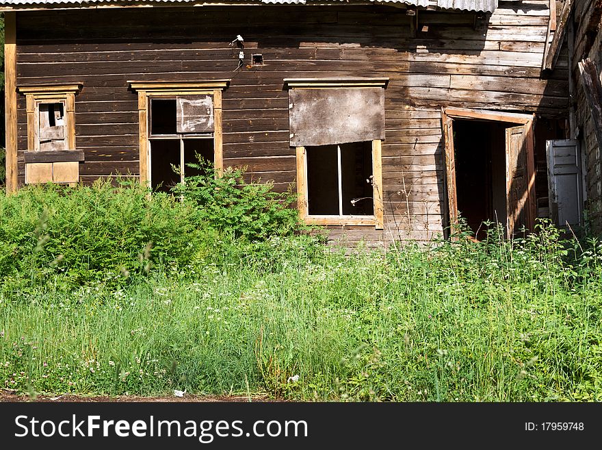 An abandoned rural wooden house, in a serious state of disrepair. An abandoned rural wooden house, in a serious state of disrepair