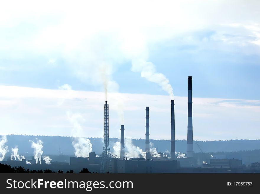 Factory buildings with smokestacks in far away. Factory buildings with smokestacks in far away