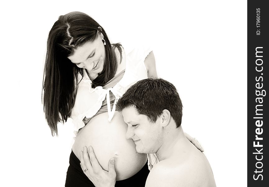 Toned image of father listening to mother's pregnant belly. Toned image of father listening to mother's pregnant belly.