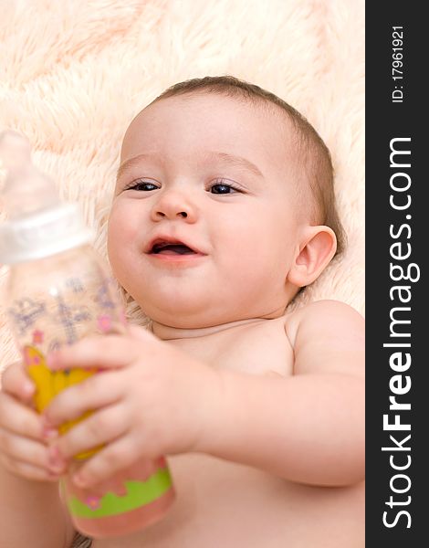 Little caucasian boy drinking water from the bottle