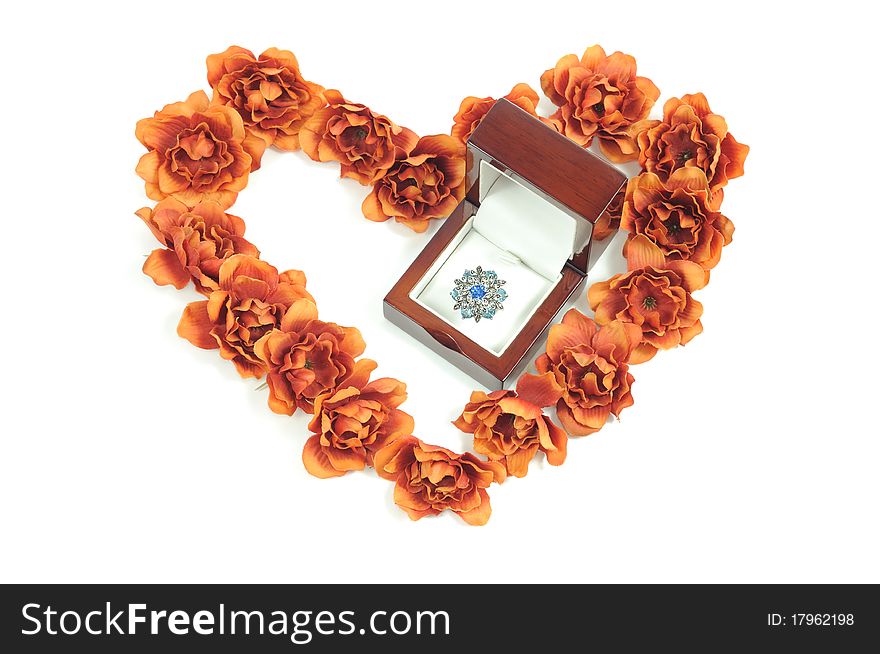 Beautiful ring in wooden box and heart from flowers. Beautiful ring in wooden box and heart from flowers