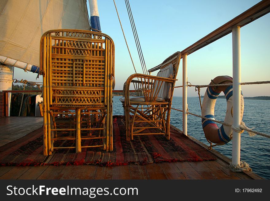 Bamboo chairs on the roof of a sailing boat on the Nile, Egypt. Bamboo chairs on the roof of a sailing boat on the Nile, Egypt.