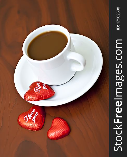 Coffee cup on the table with chocolates. Coffee cup on the table with chocolates.