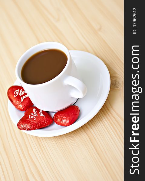 Coffee cup on the table with chocolates. Coffee cup on the table with chocolates.