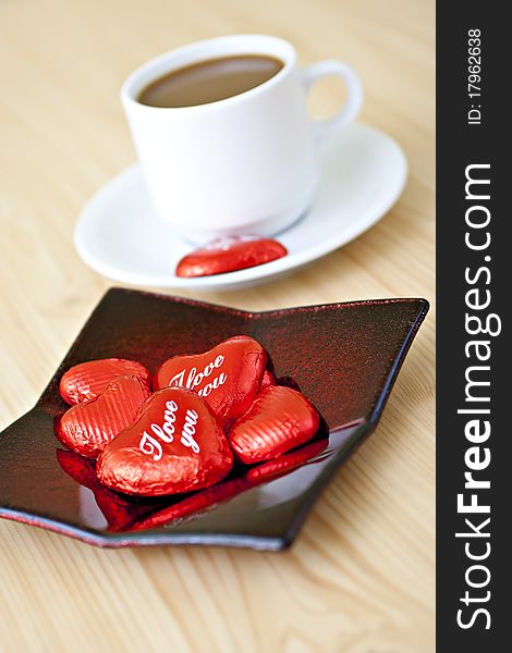 Coffee cup on the table with chocolates. Coffee cup on the table with chocolates.