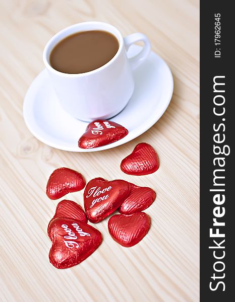 Coffee cup on the table with chocolates. Coffee cup on the table with chocolates.