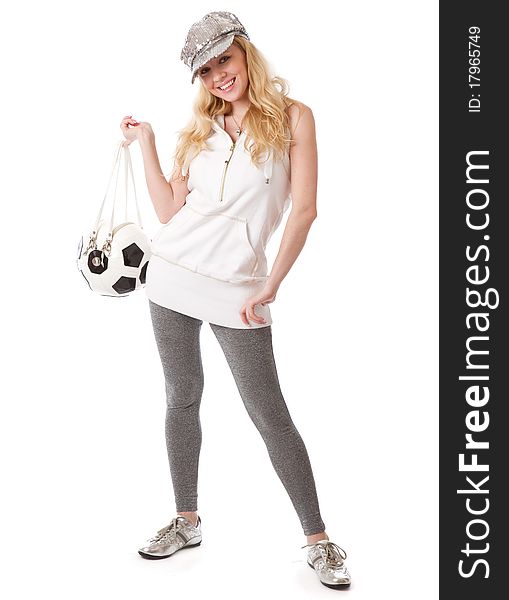 A smiling beautiful girl in a cap with a football ball. isolated on a white background. A smiling beautiful girl in a cap with a football ball. isolated on a white background