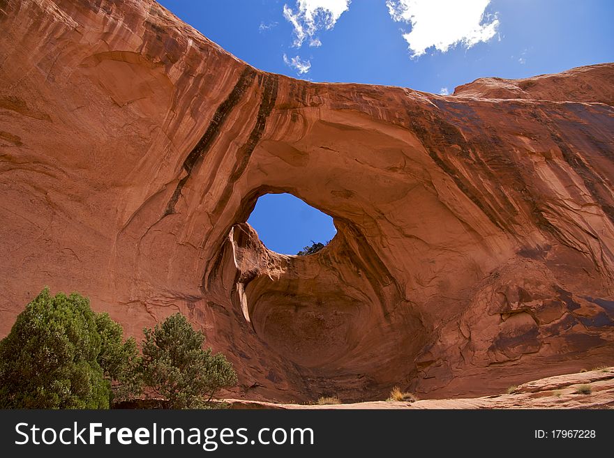 Bowtie Arch, a pothole arch formed when a pothole broke through from the top of the cliff. Corona Arch Trail, Moab, just outside Arches National Park.