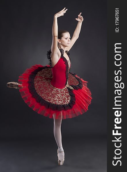 Picture of a beautiful ballerina posing in a red tutu. Picture of a beautiful ballerina posing in a red tutu