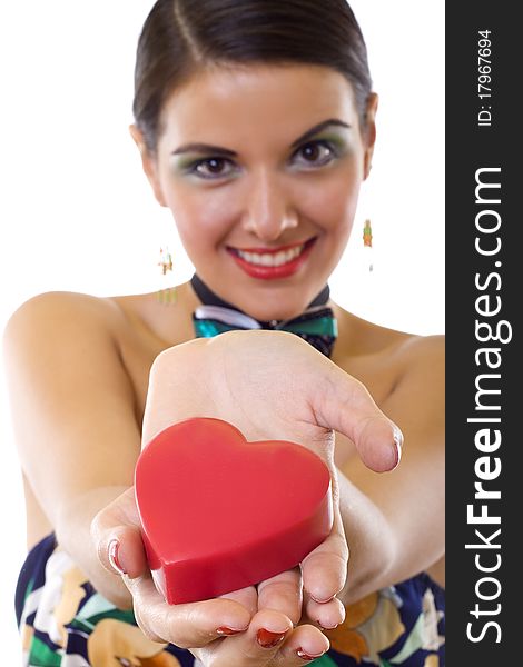 Wide angle of a beautiful woman holding a big red heart