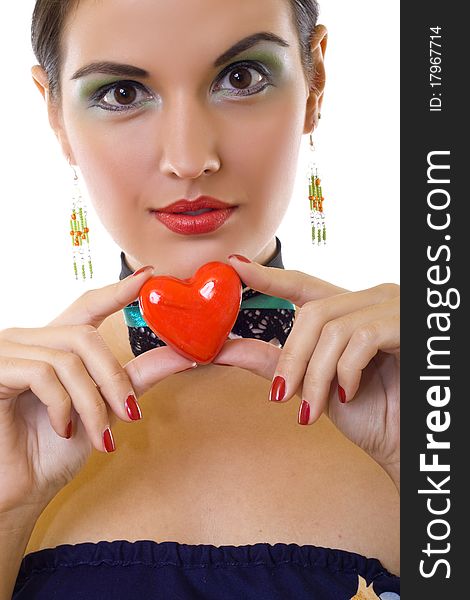 Portrait of a charming young girl on a white background holding a heart. Portrait of a charming young girl on a white background holding a heart