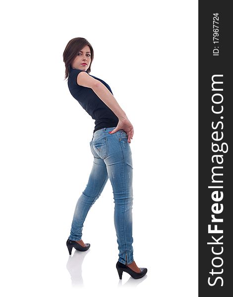 Back of a girl in jeans posing in studio