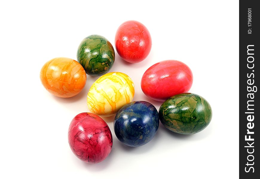 A selection of shiny painted easter eggs on a white background