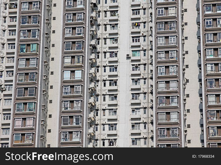 It is the private residential building in downtown of Hong Kong. It is in grey and white colour. It is the private residential building in downtown of Hong Kong. It is in grey and white colour.