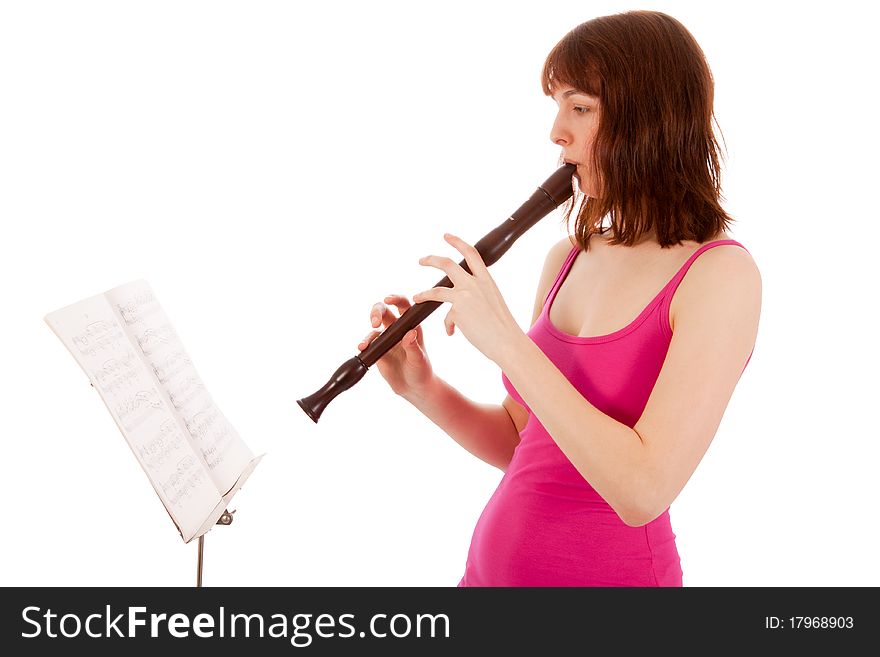 A beautiful young woman is playing a whistle. A beautiful young woman is playing a whistle