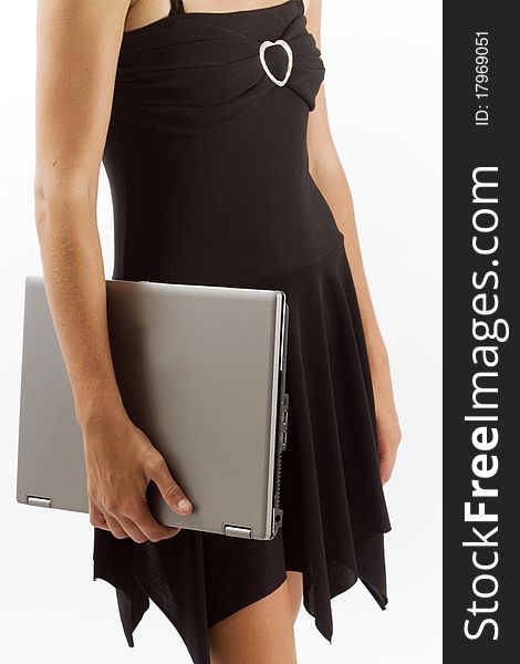 Cropped image of a young business executive woman holding a closed laptop computer by her side. Cropped image of a young business executive woman holding a closed laptop computer by her side