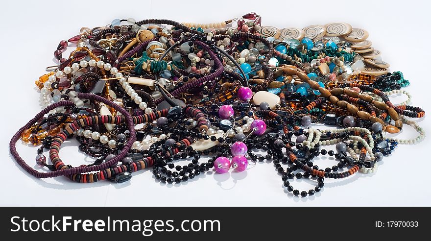 A taangled pile of beads and necklaces isolated on white. A taangled pile of beads and necklaces isolated on white