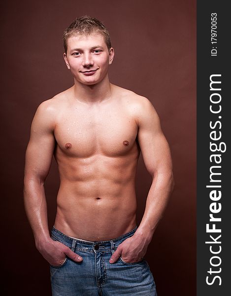 Young muscled model posing in studio. Young muscled model posing in studio