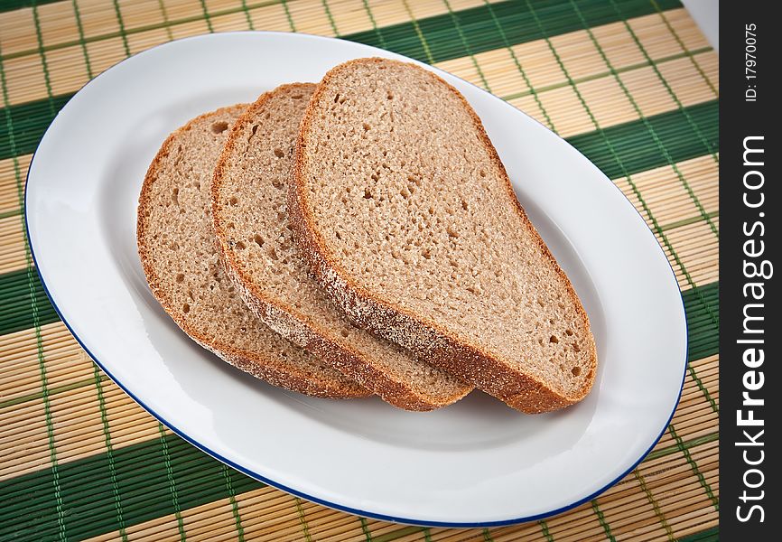 Three slices of brown bread on a plate