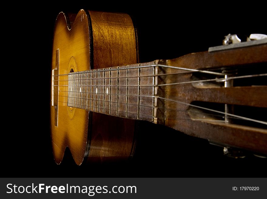 Classical guitar on black background