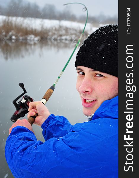 Portrait of an excited man fishing in winter time. Portrait of an excited man fishing in winter time