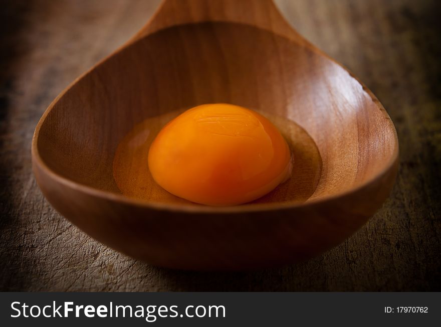 Egg on wooden spoon