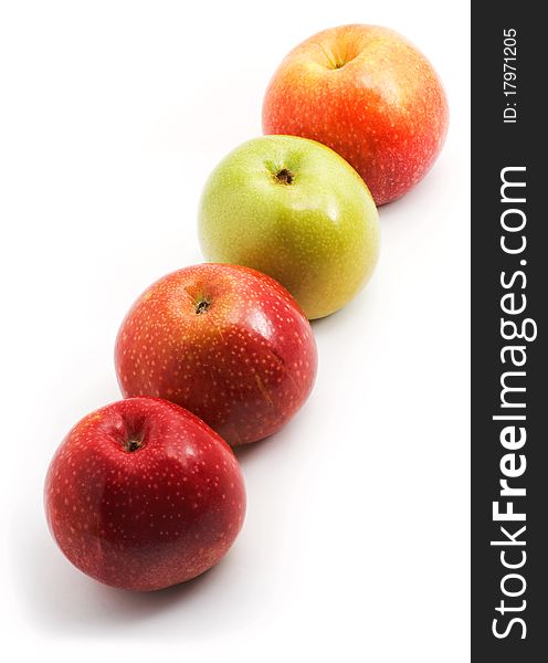 Apples in a row on a diagonal, white background