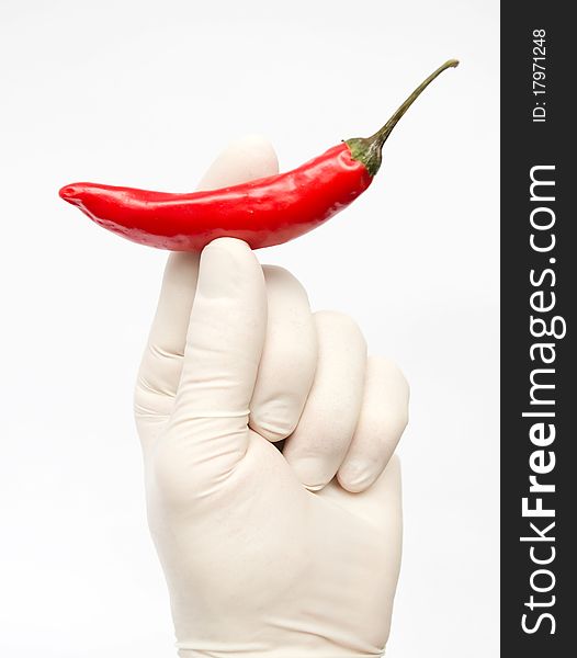 Hand with red pepper against to white background