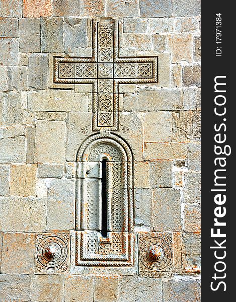 Outer wall of the monastery. Window and Cross. Outer wall of the monastery. Window and Cross