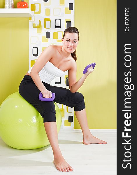 Young Girl Behooves Gym Exercise With Ball