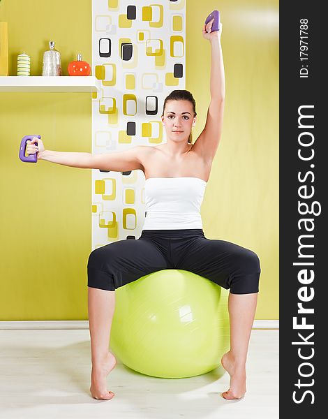 Beauty, young girl behooves gym exercise with ball