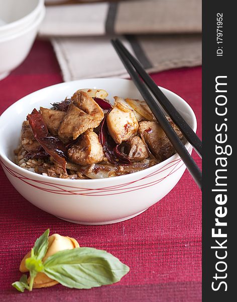 Chicken and chilli stir-fry with rice in a bowl. Chicken and chilli stir-fry with rice in a bowl