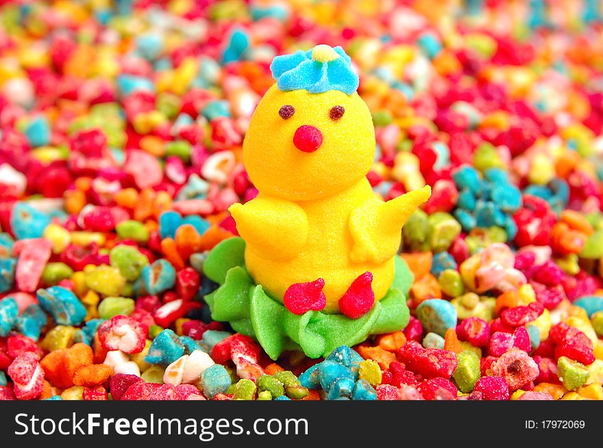 Chicken from sugar against decorative colorful candy sprinkles. Chicken from sugar against decorative colorful candy sprinkles